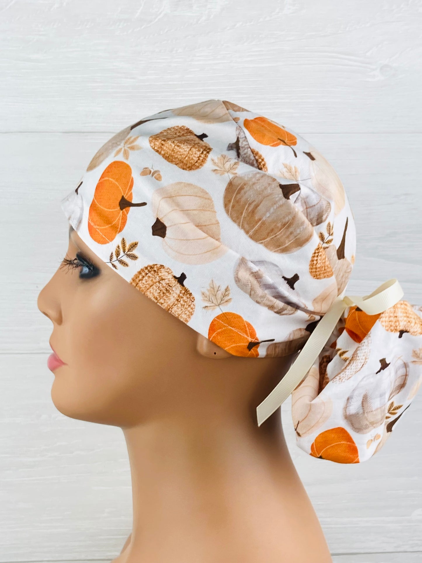 Patterned Pumpkins on Cream Ponytail Scrub Hat