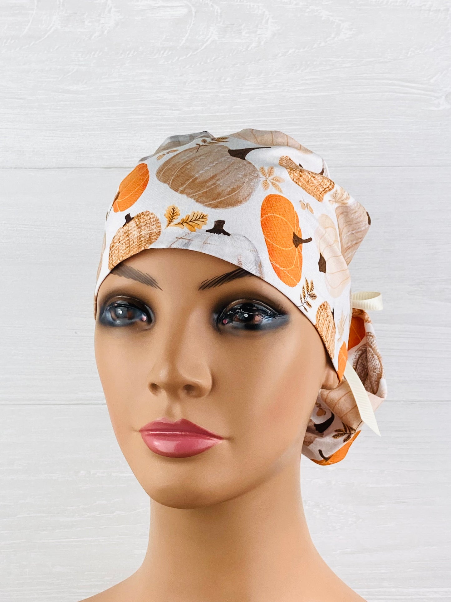 Patterned Pumpkins on Cream Ponytail Scrub Hat
